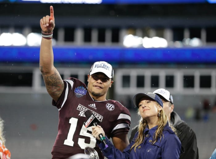 Mississippi State Bulldogs quarterback Dak Prescott (15) accepts the Belk Bowl MVP trophy after defeating the North Carolina State Wolfpack in the 2015 Belk Bowl at Bank of America Stadium. The Bulldogs defeated the Wolfpack 51-28.